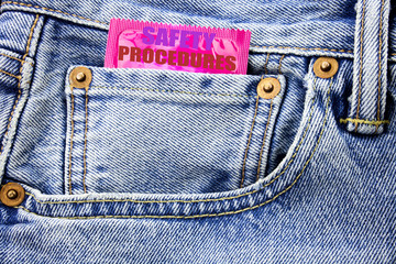 Handwritten text showing Safety Procedures. Business concept writing for Accident Risk Policy Written on condom pack in small pocket in the pants jeans.