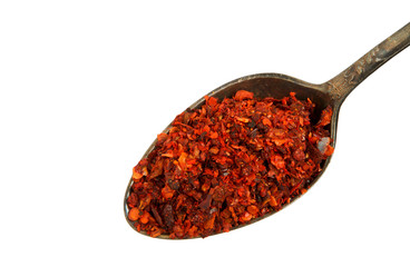 Mixing slices of pepper in an old spoon isolated on a white background. View from above. Spices in a spoon on isolate.