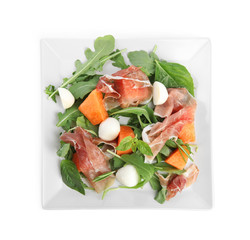 Fresh melon with prosciutto, mozzarella and arugula on white background, top view