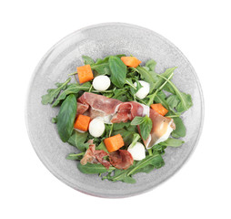 Fresh melon with prosciutto, mozzarella and arugula on white background, top view