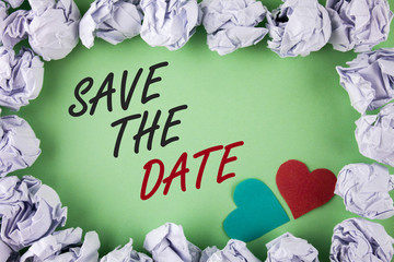 Text sign showing Save The Date. Conceptual photo Organizing events well make day special by event organizers written plain green background within White Paper Balls Hearts next to it.