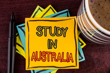 Writing note showing Study In Australia. Business photo showcasing Graduate from oversea universities great opportunity written Sticky Note paper Wooden background Coffee Cup and Marker