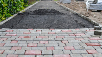 Paving new sidewalk with paving blocks