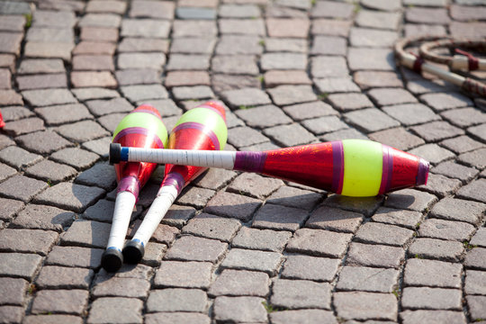 multicolored juggling stick on a cobbled street in a soft backlight77