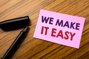 Word, writing We Make It Easy. Business concept for Help Quality Solution Written on sticky note red paper, wooden background pen. Note stick on the desk.