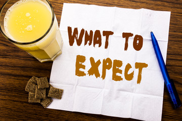 Handwriting Announcement text showing What To Expect. Business concept for Achieve Expectation written on tissue paper on wooden background with pen and healthy juice in the restaurant