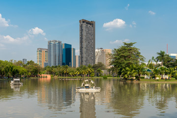 Fototapeta premium The Chatuchak park is one of the oldest public parks in Bangkok. An artificial lake runs along this thin and long park with numerous bridges crossing the lake. A train museum is situated in the park.