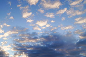 White and black clouds against the blue sky.