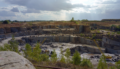 Top View of granite stone mine layers with heavy equipment inside