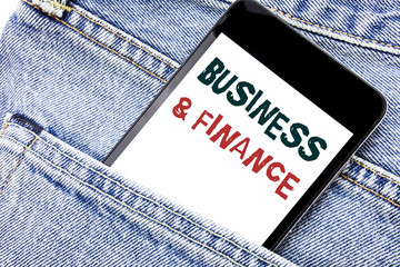 Handwriting Announcement text showing Business And Finance. Business concept for Company Strategy Written phone mobile phone, cellphone placed in man front jeans pocket.