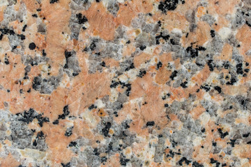 Texture of reddish color stone with quartz. Stone background.