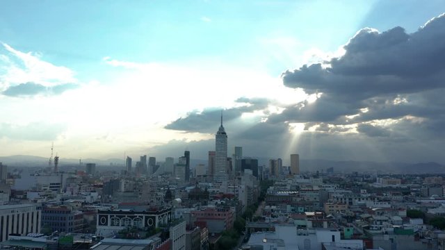 dusk view of Mexico City's business district tilting down & flying backwards over National Cathedral