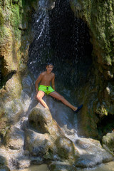 Boy under a Krka waterfalls in Croatia . Europe