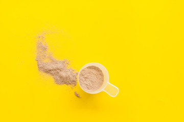 Nutrition for workout with protein cocktail powder on yellow background top view mockup