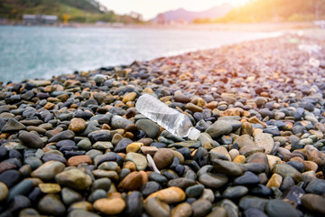 A plastic water bottle thrown away on the beach