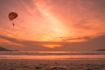 Sunset lovers, bright orange sky, on the beach Famous Phuket Patong Thailand