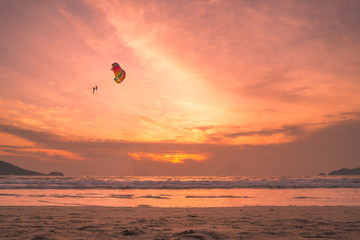 Fototapeta na wymiar Sunset lovers, bright orange sky, on the beach Famous Phuket Patong Thailand