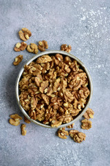 Bowl of peelled walnuts. Top view with copy space.