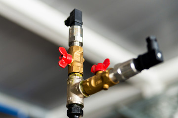 Fittings and valve, pipes and adapters. Plumbing fixtures and piping parts. focus on the red crane