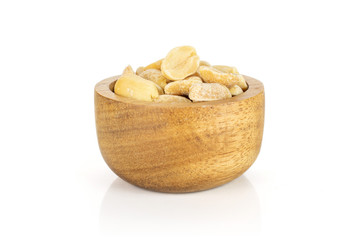 Lot of halves of natural yellow peanut in tiny wooden bowl isolated on white background