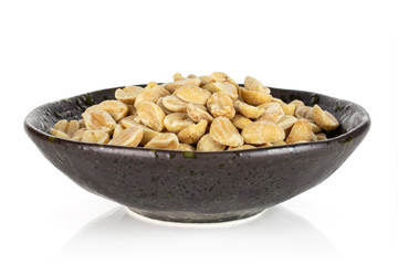 Lot of halves of natural yellow peanut in dark ceramic bowl isolated on white background