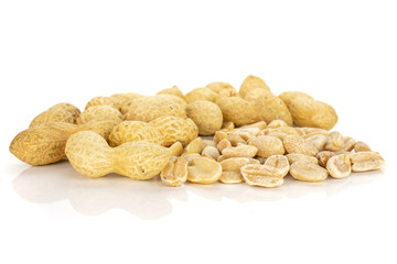 Lot of whole lot of halves of natural yellow peanut isolated on white background