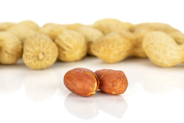 Lot of whole natural yellow peanut isolated on white background