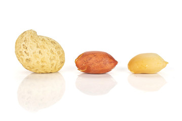 Fototapeta na wymiar Group of three whole natural yellow peanut in closeup isolated on white background