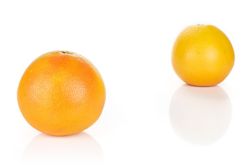Group of two whole fresh pink grapefruit placed diagonally in line isolated on white background