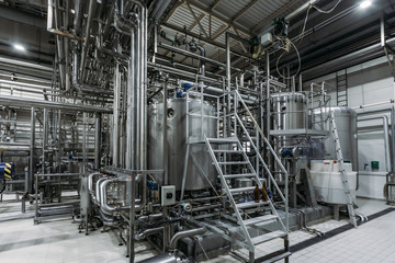 Modern brewing equipment in beer factory, steel vats for fermentation and maturation of beverage
