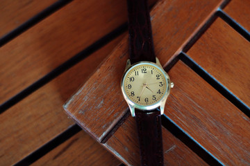 Quartz watch on a wooden background.