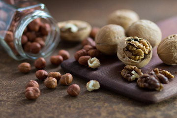 Filbert and walnuts on a rusty metal surface. 