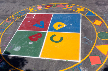 Colorful elementary school playground with circle and square design elements.