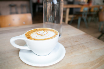 Cinnamon Latte in white mug on table at coffee shop