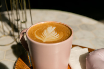 honey and lavender latte in pink mug with iced vegan donut, white background, hipster coffee shop, latte art