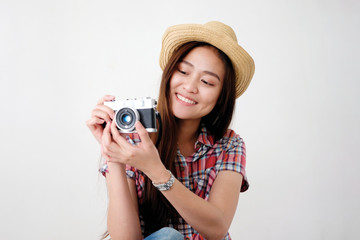 Young happy asian woman tourist holding camera, Asian traveler girl smiling while holding vintage camera on vacation