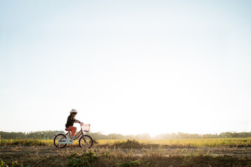 Obraz premium toddler enjoy riding her bicycle outdoor in beautiful day