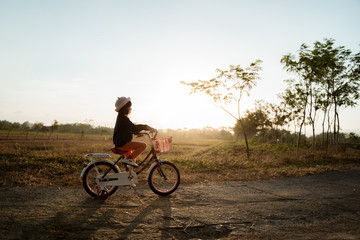 Naklejka premium toddler enjoy riding her bicycle outdoor in beautiful day