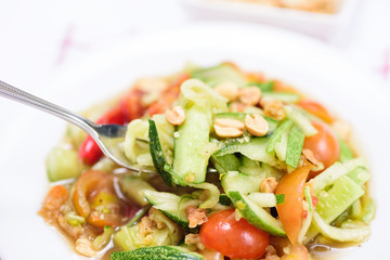 Eating spicy cucumber salad, Thai food
