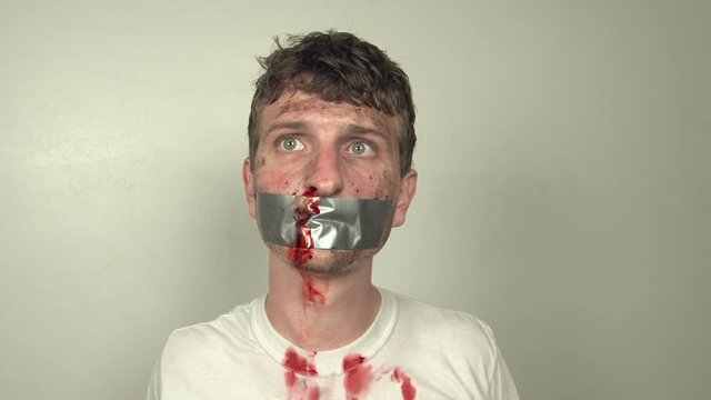 Nervous man with duct tape on mouth