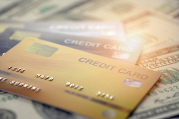 close up and selective focused of credit card on banknote background