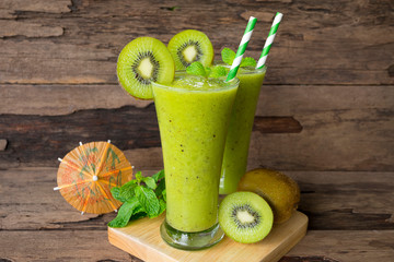 Kiwi apple yogurt juice smoothies healthy  green beverage taste delicious drink summer have prote colorful in the glass and fruit kiwi yellow on wood background.