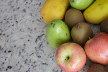 Fruits (kiwi, apple, bananas and pears) on the left