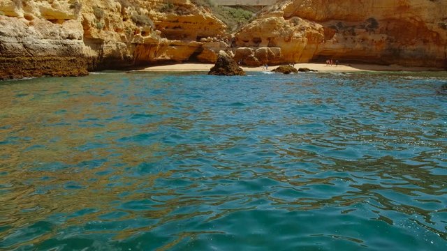 Stunning slow motion shot of Carvoeiro beach in The Algarve, Portugal, with turquoise waters and amazing rock formations