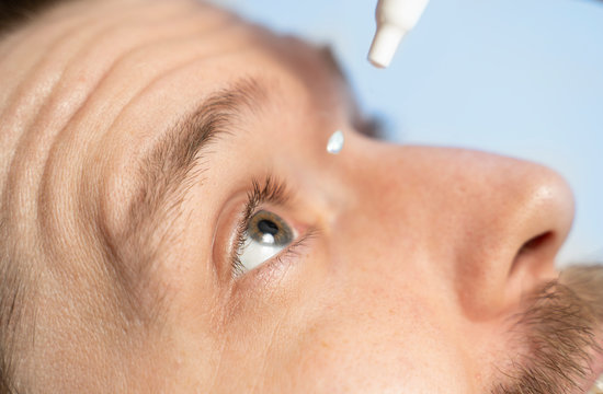 Closeup Man Applying Eye Drops, Drop In Mid Air 