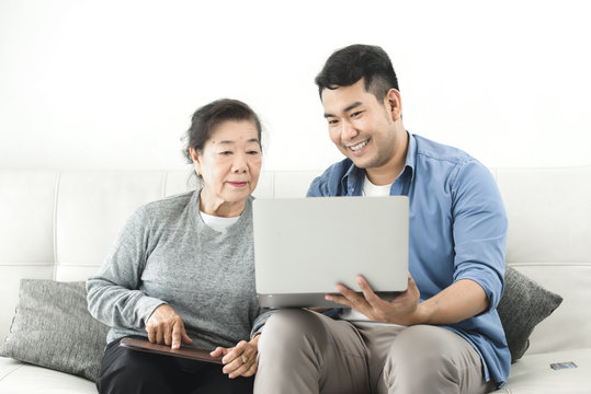 Asian agent man deal with senior for life insurance contract signed, business concept.