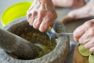 Hands are squeezing lemon, cooking Thai food