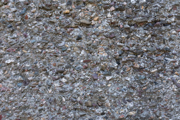 Concrete wall where small pebbles are processed