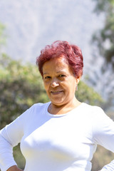 Older Latina woman with reddish hair