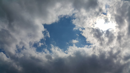 beautiful background of clouds, clearly visible lines of white clouds and blue sky, the top is a sunbeam, copy space for text